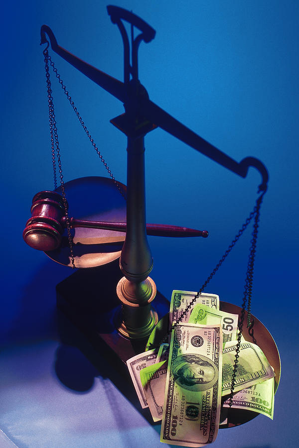 Gavel versus cash on scales of justice Photograph by Comstock