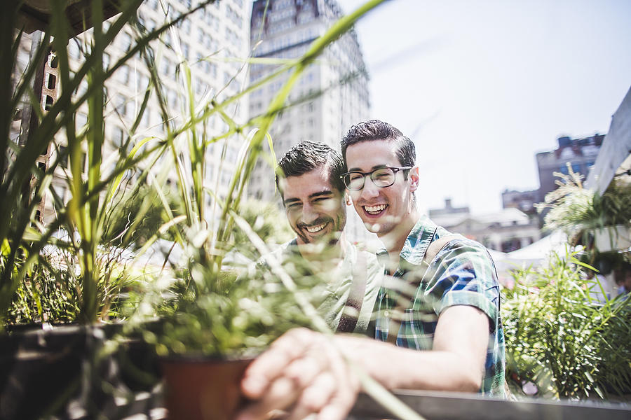 Gay couple buying plants Photograph by Cultura RM Exclusive/Chad Springer