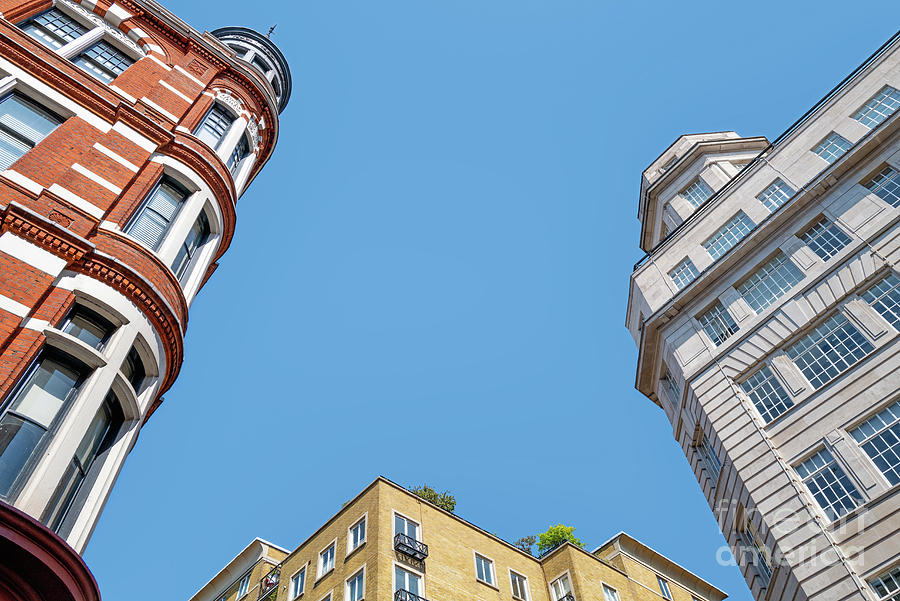 Generic London architecture in three styles and colours. Blue sky background with space for text. Photograph by Jane Rix
