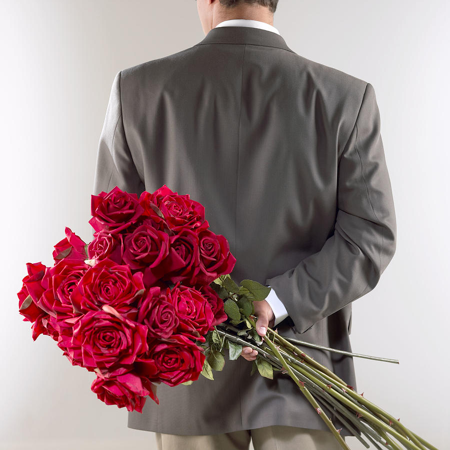 Gentleman with red roses Photograph by Brand X Pictures