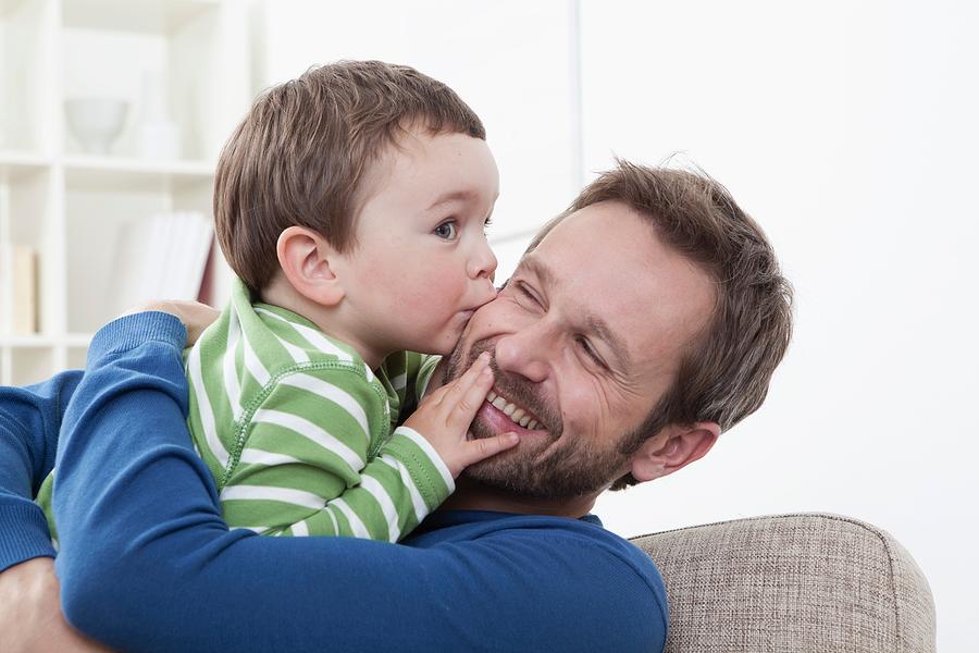 Germany, Bavaria, Munich, Son (2-3 Years) kissing his father, smiling Photograph by Westend61