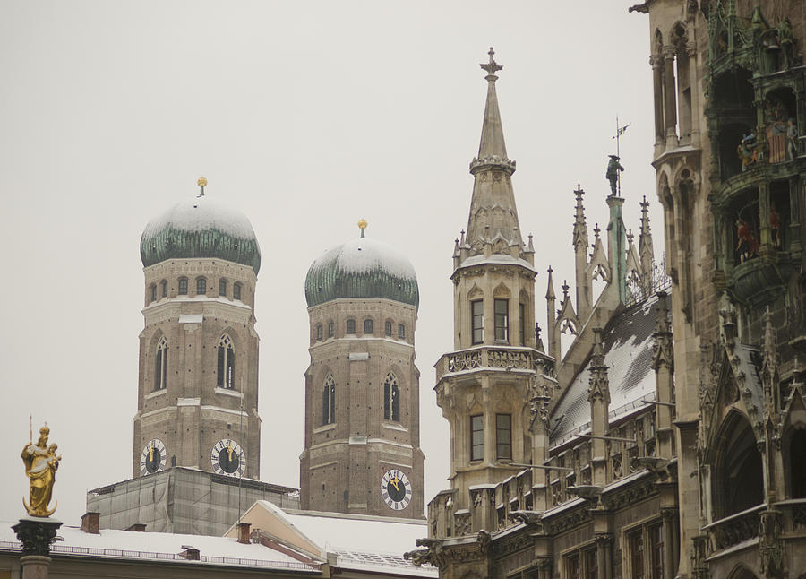Germany, Bavaria, Munich, View Of Snow Covered Bavarian Church. Church Of Our Lady (German: Dom Zu Unserer Lieben Frau) With Tower Of The New Town Hall, Or Neues Rathaus At Marienplatz. Photograph by Kypros