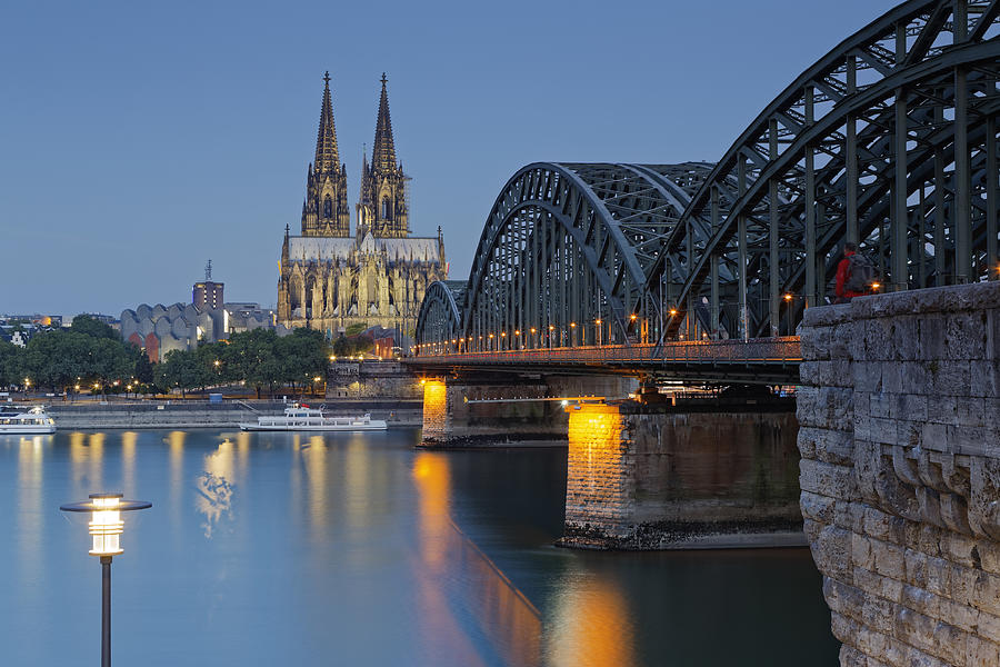 Germany, Cologne, lighted Cologne Cathedral and Hohenzollern Bridge Photograph by Westend61