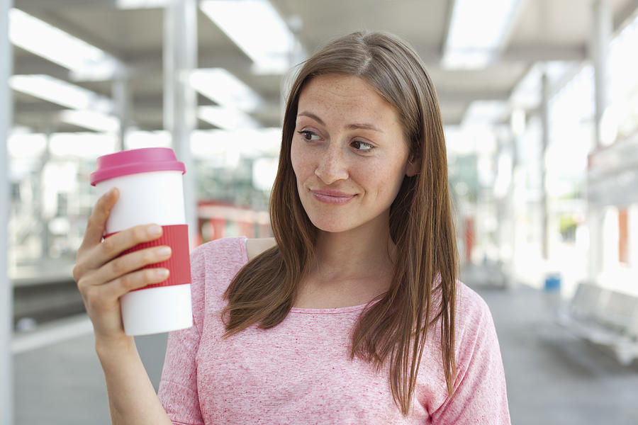 Germany, North-Rhine-westphalia, Duesseldorf, Young woman holding coffee cup Photograph by Westend61