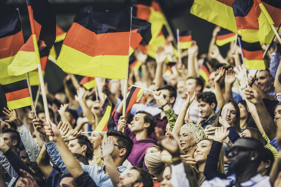 Germany supporters waving their flags on a stadium Photograph by Vm