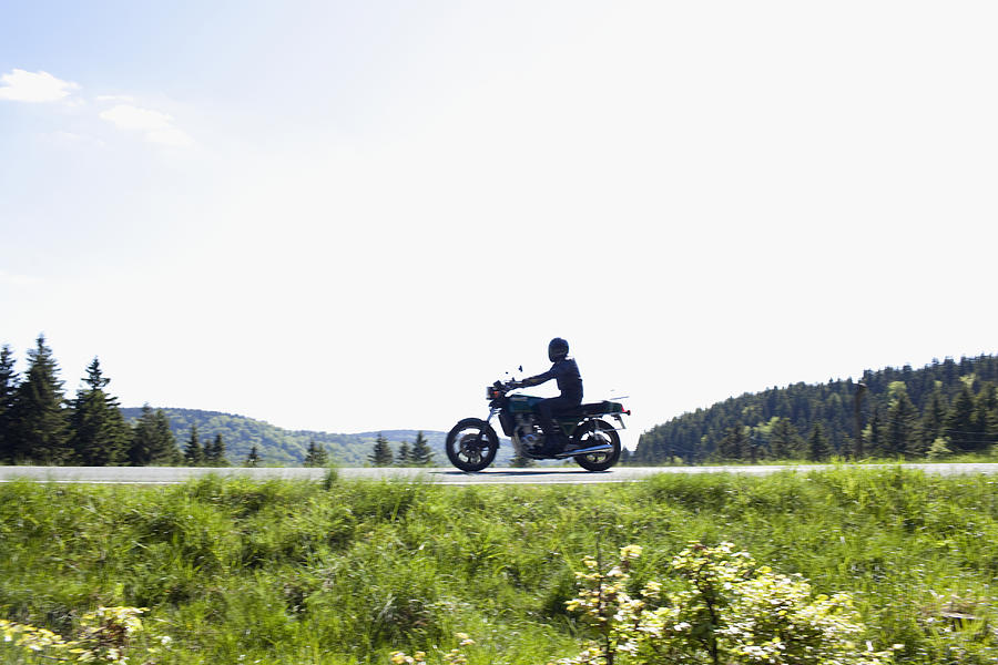 Germany, Thuringia, Suhl, Motorbike on country road Photograph by Tetra Images - Johannes Kroemer