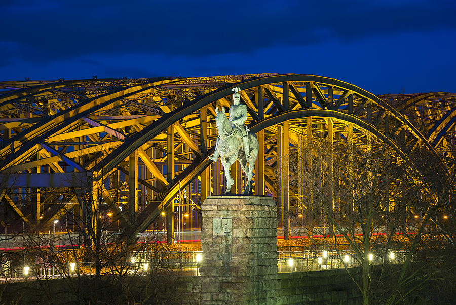 Germnay, North Rhine-Westphalia, Cologne, equestrian statue of emperor Wilhelm II in front of lighted Hohenzollern Bridge by night Photograph by Westend61