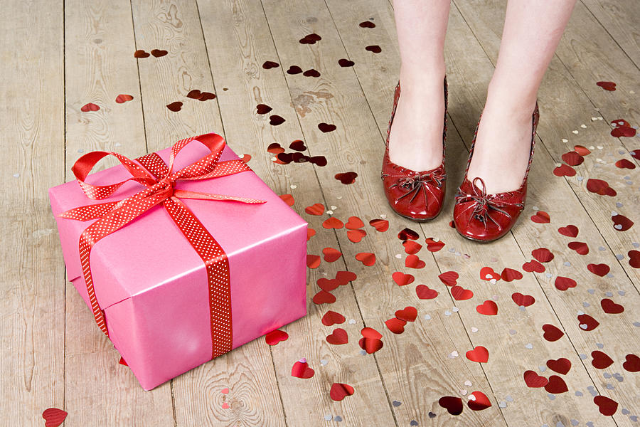 Gift and feet of woman Photograph by Image Source