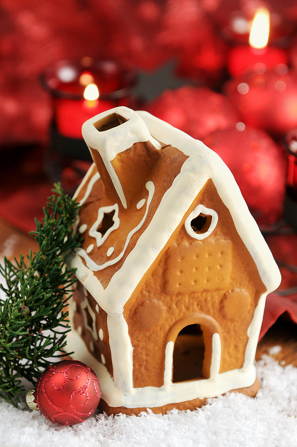 Gingerbread house with candle and Christmas ornaments Photograph by Hsvrs