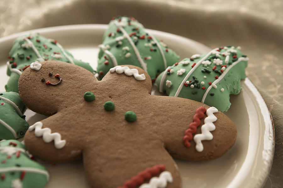 Gingerbread man and Christmas cookies on plate, elevated view Photograph by Thomas Northcut