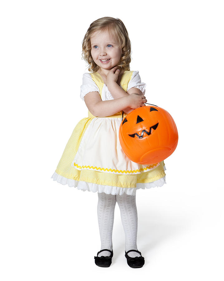 Girl (2-3) in Goldilocks costume with pumpkin lantern for Halloween Photograph by Nicole Hill Gerulat
