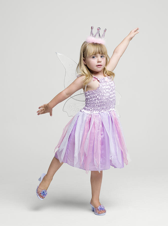 Girl (2-3 years) wearing fairy princess costume dancing, portrait, studio shot Photograph by Roger Wright