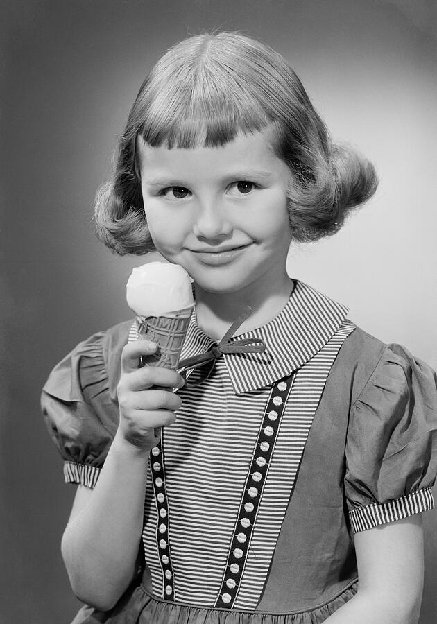 Girl (6-7) eating ice cream, portrait Photograph by George Marks