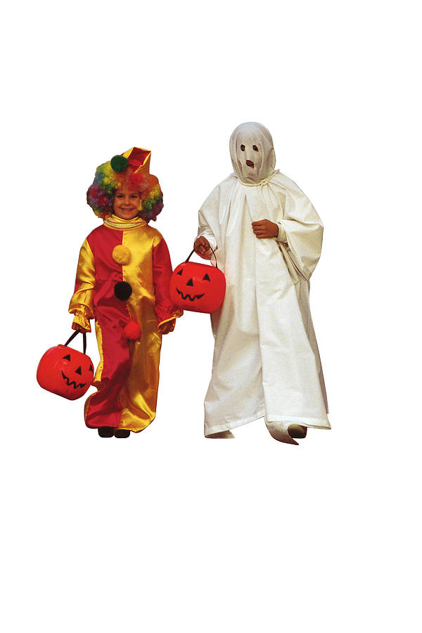 Girl and boy in Halloween costumes Photograph by Comstock