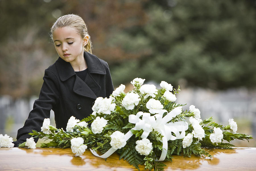 Girl At A Funeral Standing Next To A Coffin Photograph by RubberBall Productions