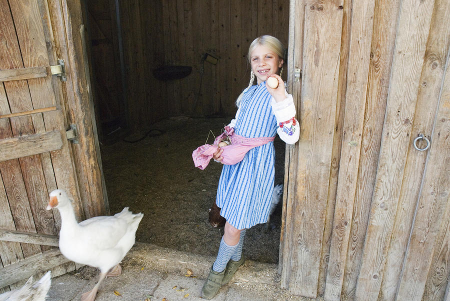 Girl carrying eggs in apron Photograph by Westend61