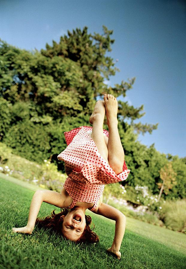 Girl doing headstand Photograph by Laurence Monneret