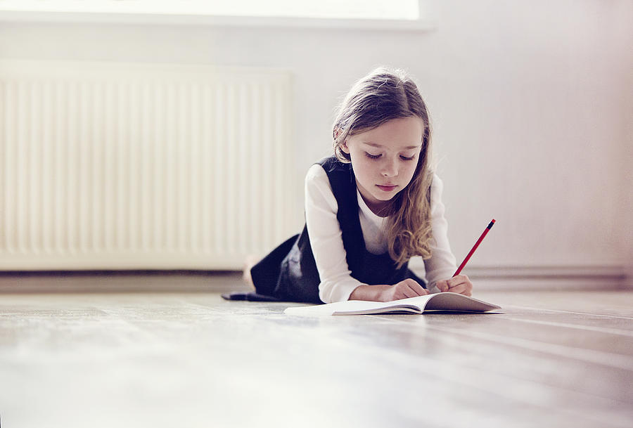 Girl doing her homework Photograph by Mrs