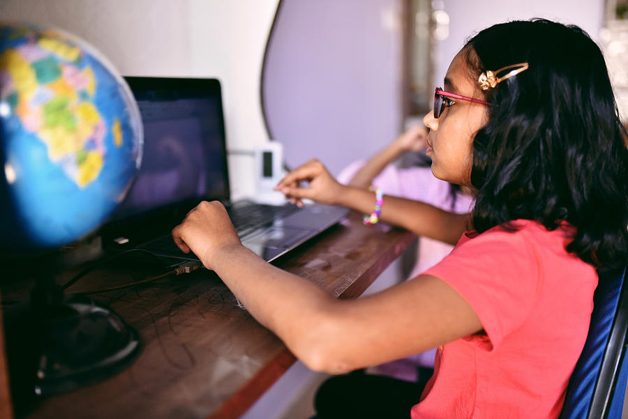 Girl doing homework on laptop Photograph by Mayur Kakade