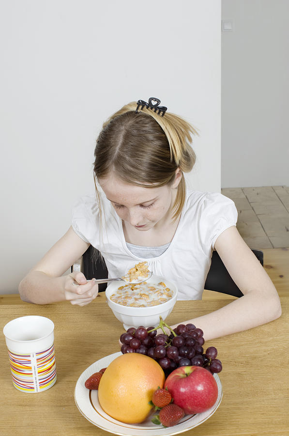 Girl eating cereals  Photograph by Muriel de Seze