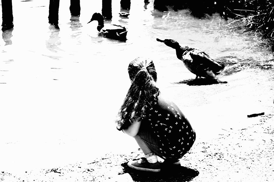 Black And White Photograph - Girl Feeding The Ducks BW by Lynne Iddon