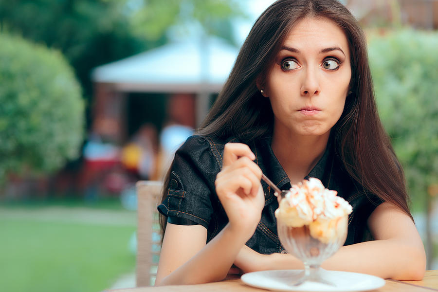 Girl Heisting to a Eat High Calorie Ice Cream Dessert Photograph by Nicoletaionescu