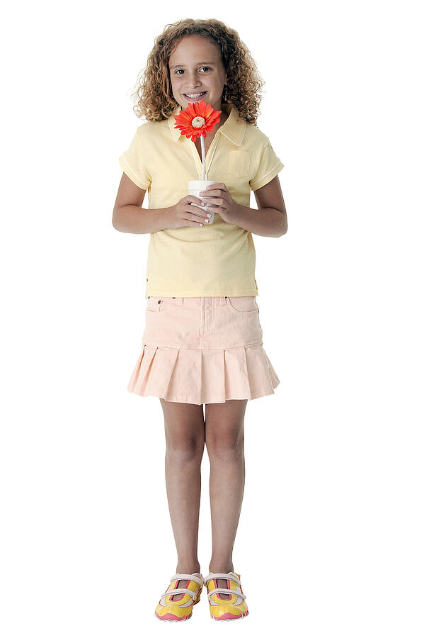 Girl holding flower Photograph by Comstock Images