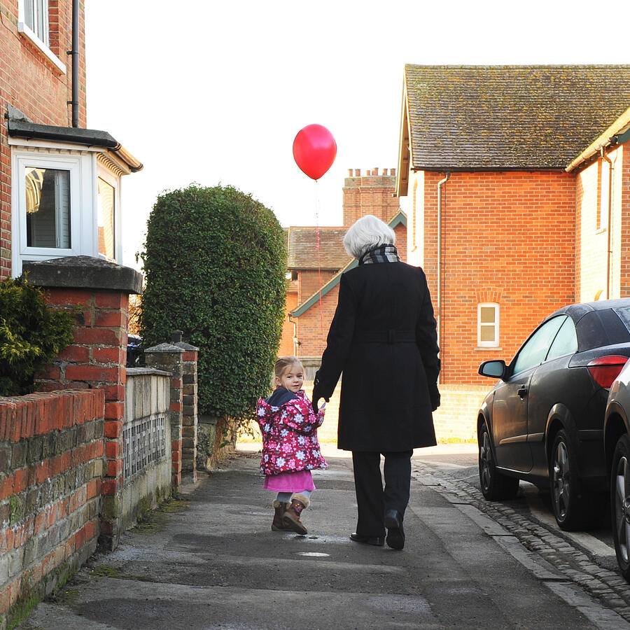 Girl holding red balloon with grandmother Photograph by Denise Balyoz Photography
