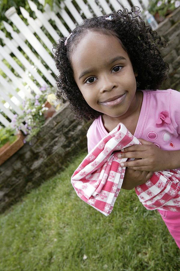 Girl holding tablecloth Photograph by Comstock Images