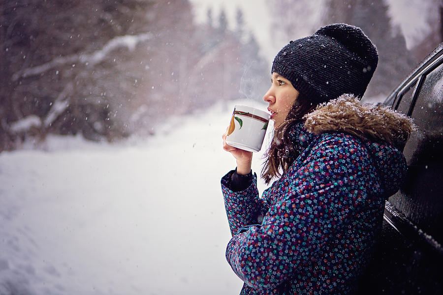 Girl is drinking hot tea in the snowy forest Photograph by Praetorianphoto