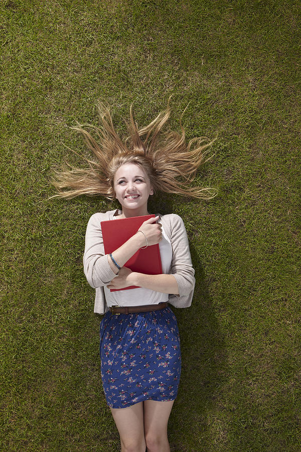 Girl lying holding a book Photograph by Tim Macpherson