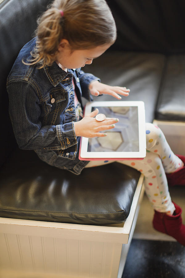 Girl on a tablet Photograph by AE Pictures Inc.