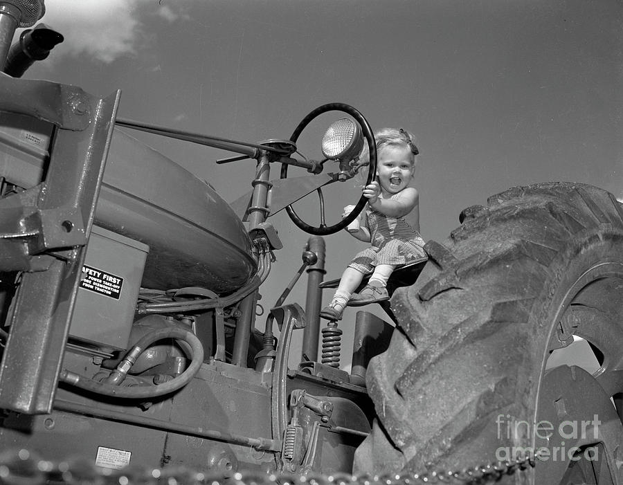 Girl on a tractor Photograph by The Harrington Collection