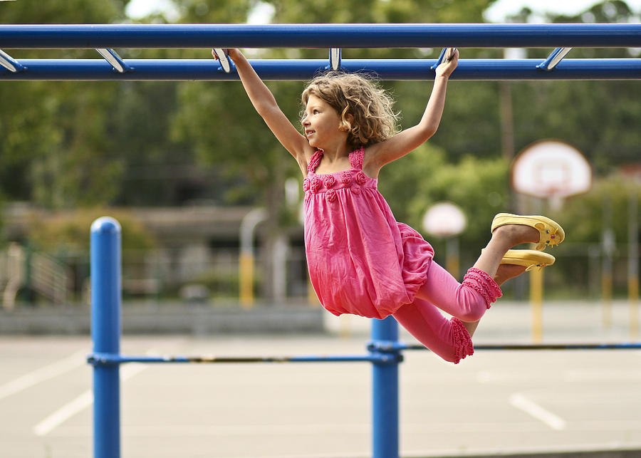 Girl on monkey bars Photograph by Image by Alison Crane Photography