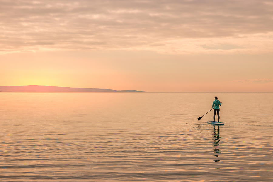 Girl paddling towards sunset Photograph by Bingokid