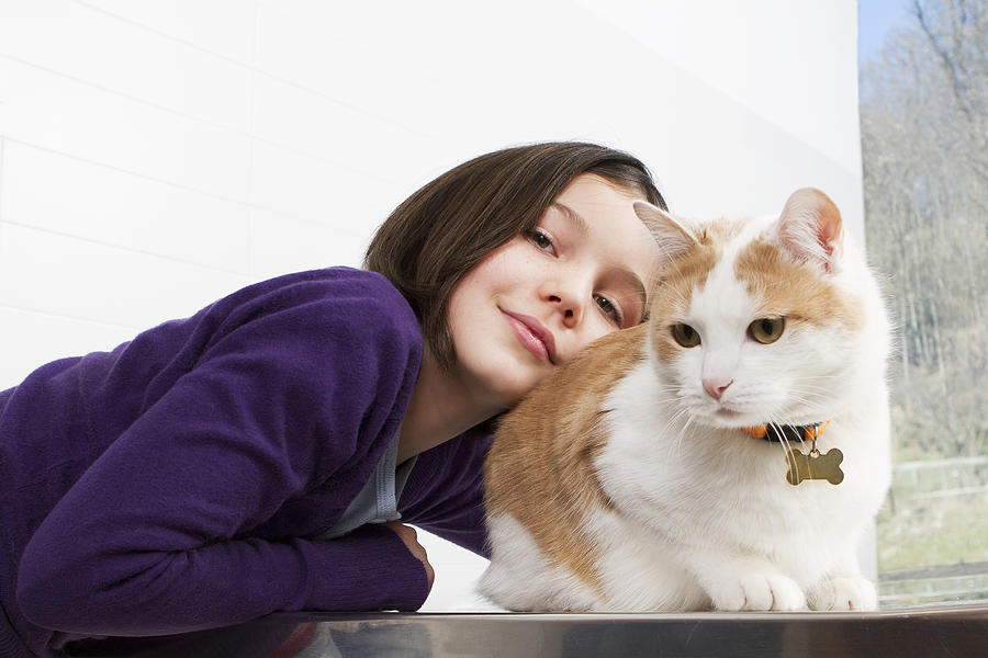 Girl petting her cat Photograph by Opificio 42