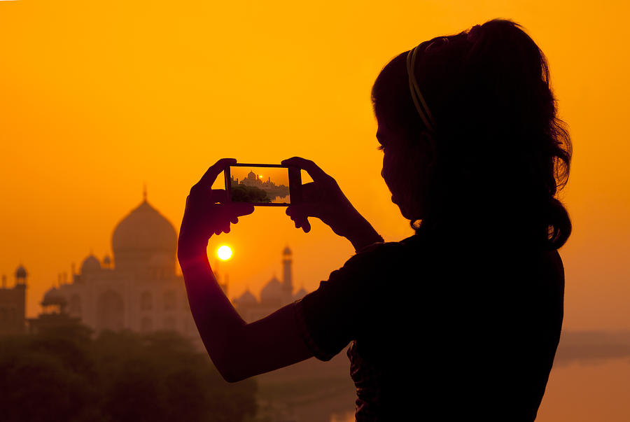 Girl photographing the Taj Mahal with a smartphone Photograph by Adrian Pope