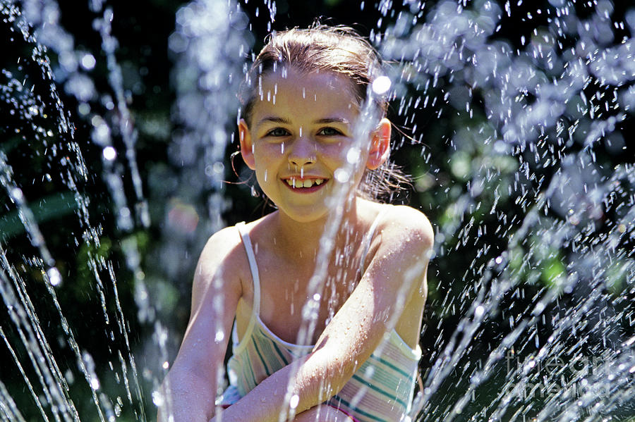 Girl Playing In Sprinkler Summer Fun  Photograph by Jim Corwin