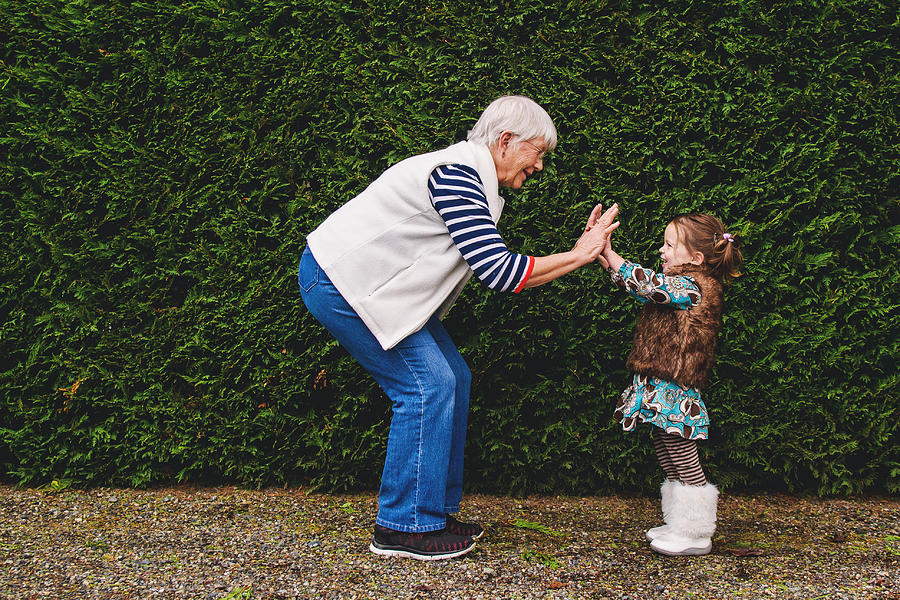 Girl playing pat-a-cake with her grandmother Photograph by Elizabethsalleebauer