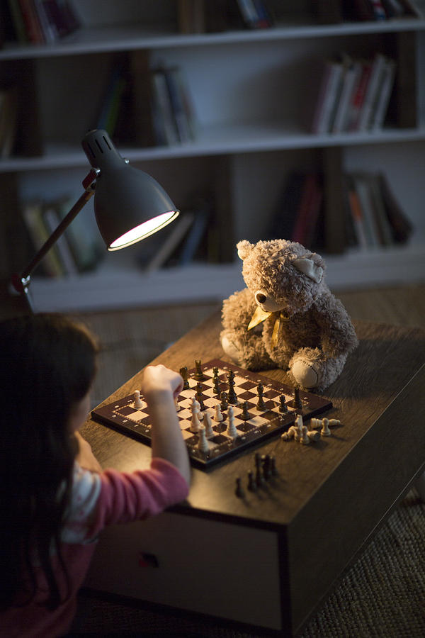 Girl plays chess Photograph by Ridvan_celik