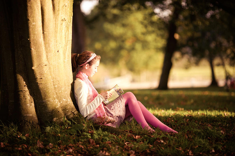 Girl reading book in autumn Photograph by Sasha Bell