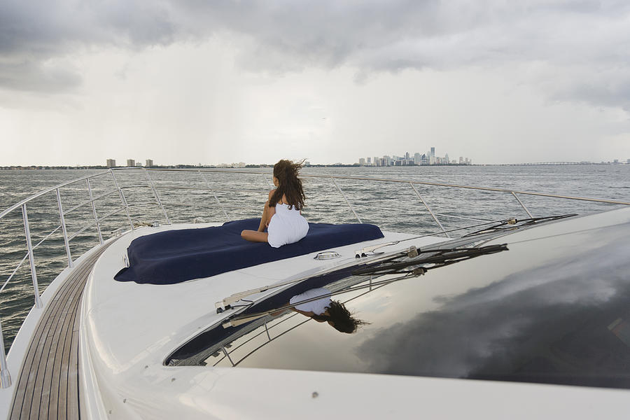 Girl relaxing on bow of boat Photograph by Juan Silva