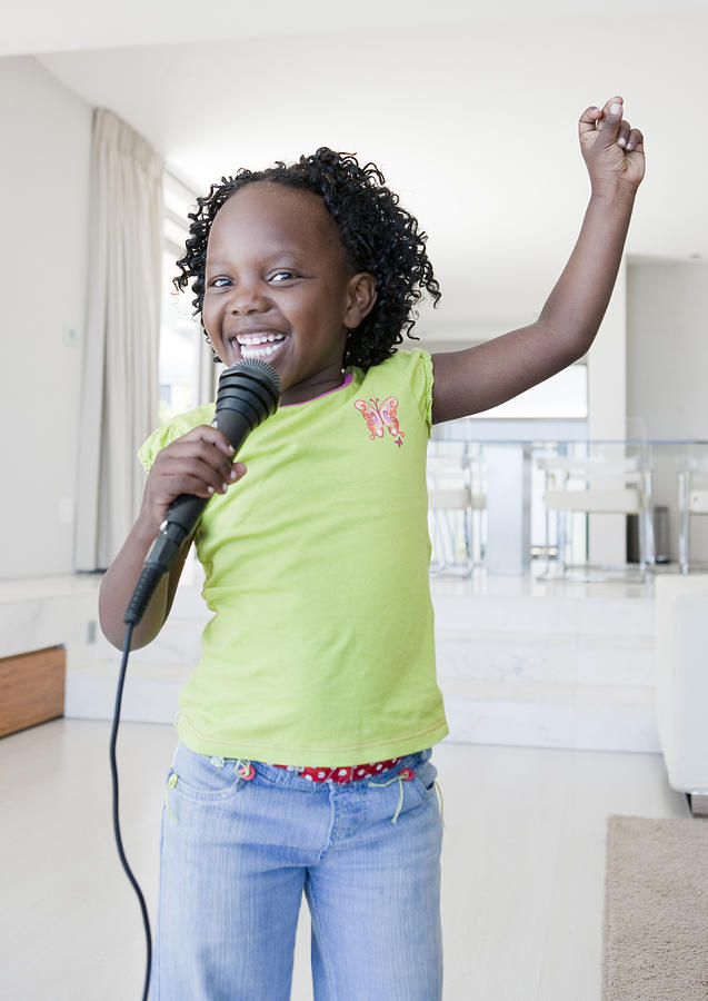 Girl singing and dancing holding microphone Photograph by Tyler Edwards