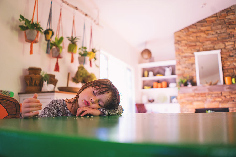 Girl sleeping at kitchen table Photograph by Elizabethsalleebauer