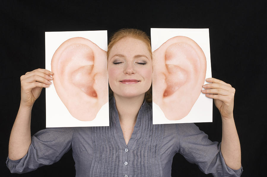 Girl Smiling And Listening With Huge Comedy Ears Photograph by John Rensten