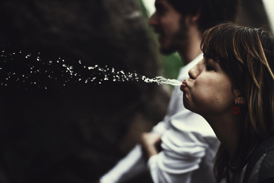 Girl spitting water Photograph by Rengim Mutevellioglu