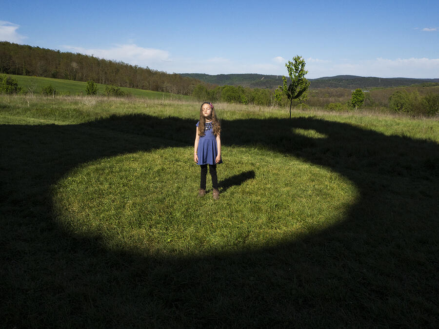 Girl standing in a field in the middle of a circle, Italy Photograph by Kira