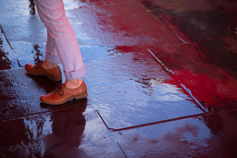 Girl standing on a wet pavement with reflection Photograph by Kevin Liu
