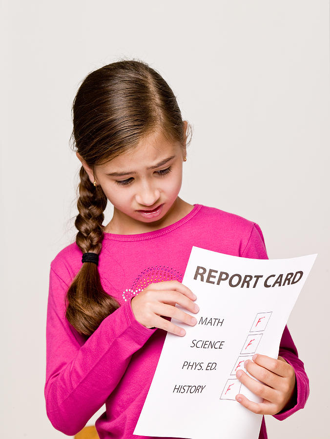 Girl student holding failing report card Photograph by Jupiterimages