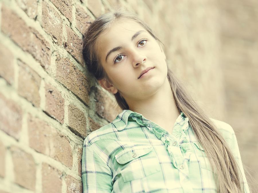 Girl, teenager, 13 years, leaning against a wall, portrait, Germany Photograph by imageBROKER/Elmar Herz